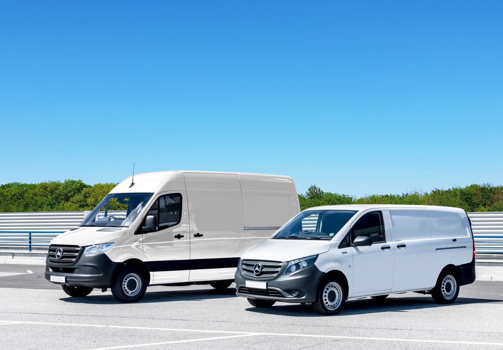 Two plain white delivery vans parked side by side, ready for branding